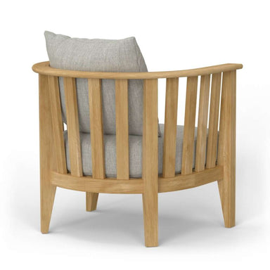 Westminster Teak Kafelonia Club Chair with a rounded slatted back, natural teak finish, and gray cushions in a rear angle view