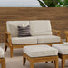 Westminster Teak Laguna Love Seat is styled on a patio with matching ottomans, showcasing a cozy outdoor seating arrangement with neutral cushions