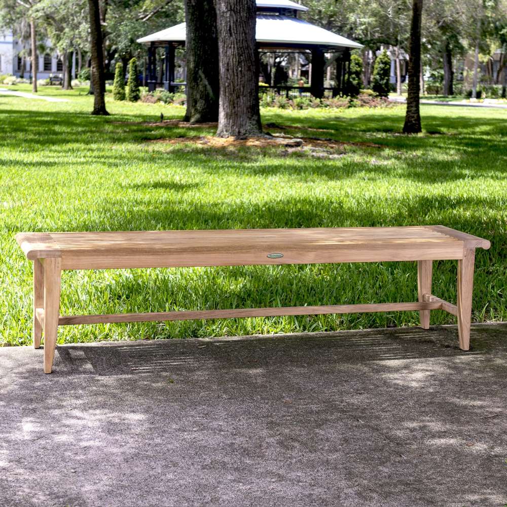 Westminster Teak Laguna Teak Backless Bench is a longer wooden bench sitting outdoors on a walkway