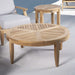 Westminster Teak Laguna Teak Coffee Table is styled indoors on a rug, paired with matching wooden chairs and soft cushions