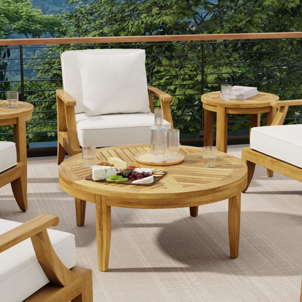 Westminster Teak Laguna Teak Coffee Table sits at the center of an outdoor seating area, surrounded by cushioned chairs and holding drinks and snacks