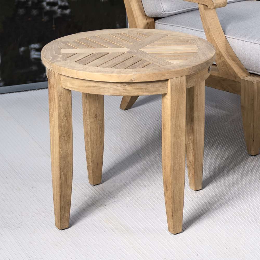 Westminster Teak Laguna Teak Side Table sits next to a lounge chair, showing its practical use as a convenient outdoor side surface