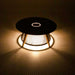 Westminster Teak Luna Coffee Table glowing at night with warm light shining through its rope base