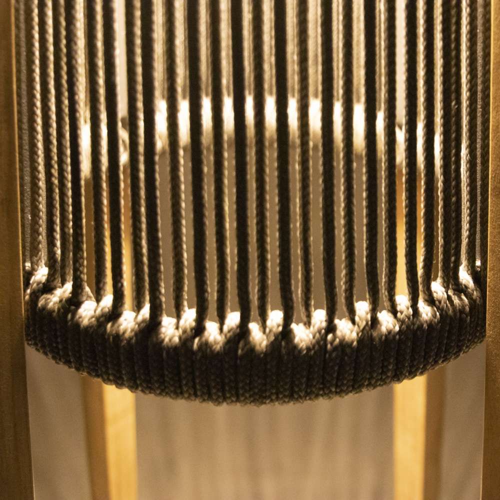 Westminster Teak Luna Standing Lamp features evenly spaced vertical ropes that softly glow as warm light shines through them from inside