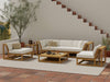 Westminster Teak Maya 6pc Lounge Sofa Set is arranged on a tiled patio with a rug, surrounded by plants and a staircase, featuring light cushions and a wooden frame