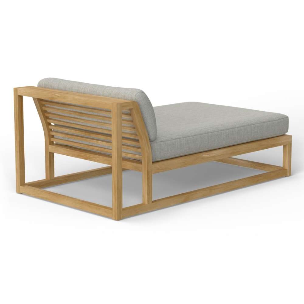 Westminster Teak Maya Chaise showcases a slatted teak backrest with an open frame design and a thick, comfortable gray seat cushion