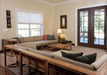 Westminster Teak Maya Corner Sectional is arranged indoors with matching pieces, creating a spacious living room setup with wood tables and soft neutral cushions