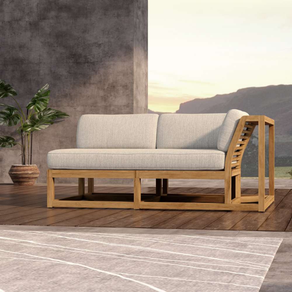Westminster Teak Maya Left Side Sectional is placed indoors on a wooden floor near a plant, blending modern design with a natural setting