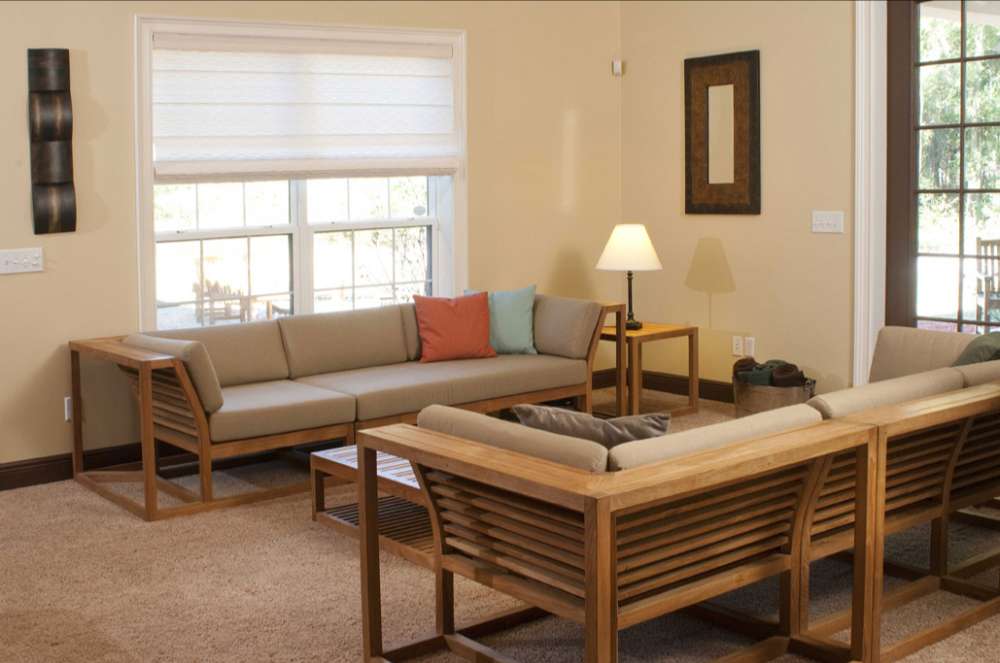 Westminster Teak Maya Right Side Sectional arranged indoors with matching seating, cushions, and tables in a cozy living room