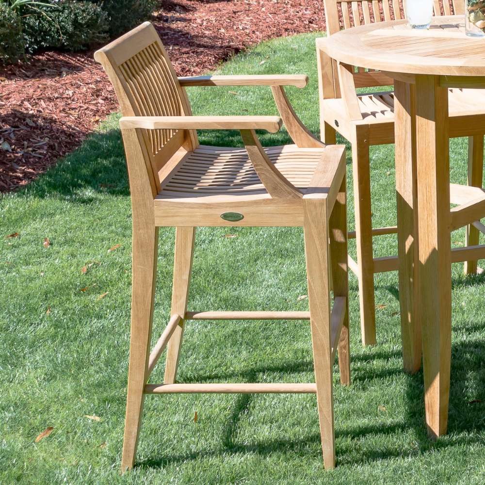 Westminster Teak Somerset Backless Bar Stool outdoors near a round teak bar table on grass