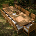 Westminster Teak Veranda Teak Table in an overhead outdoor dining layout surrounded by matching chairs on the grass