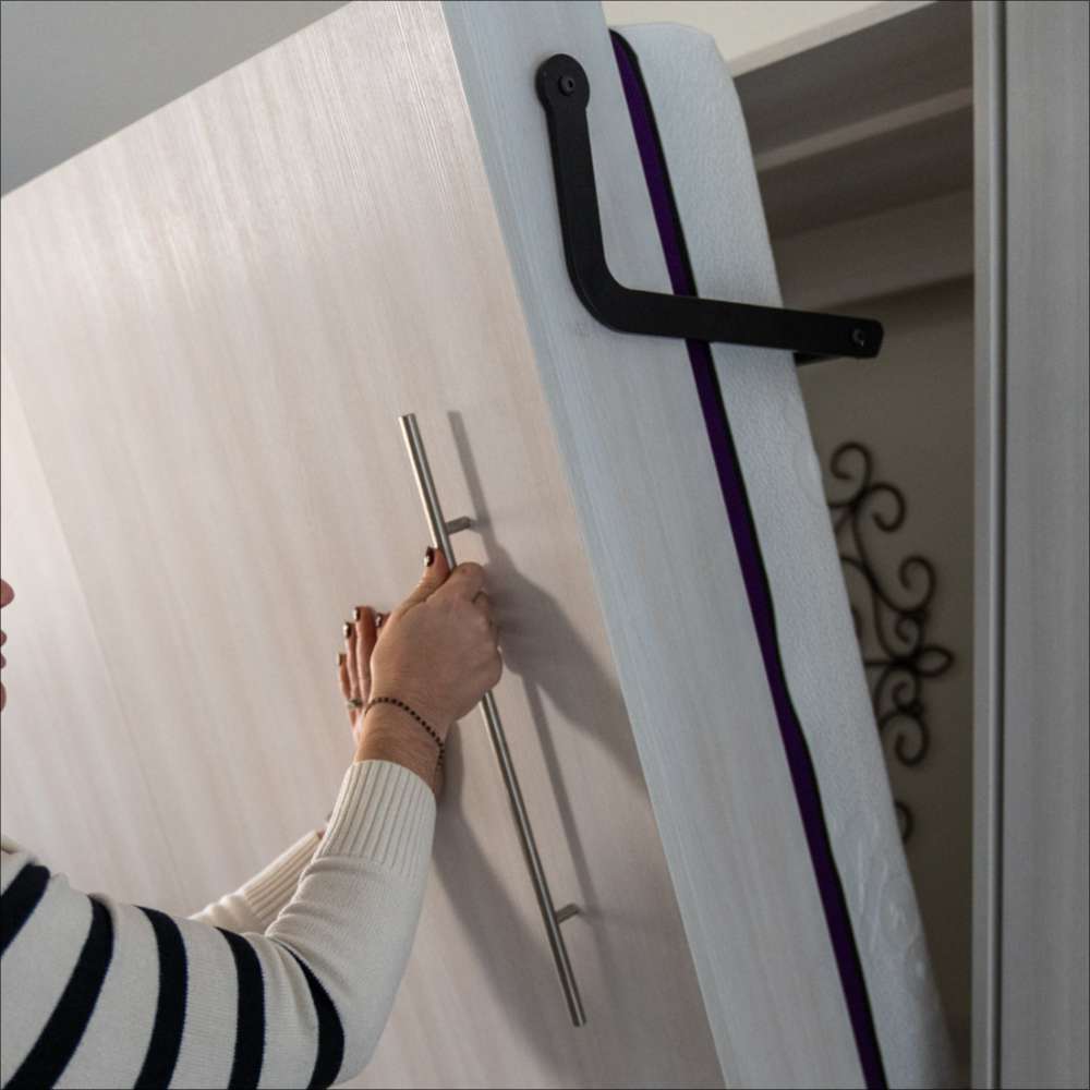 White Inovabed Wall Bed close-up shows the cabinet handle and lifting mechanism while being opened