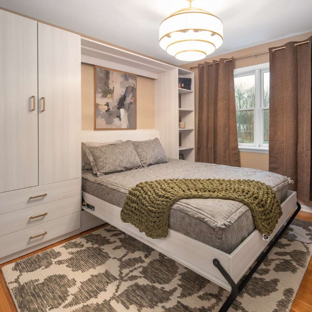 White Inovabed Wall Bed opened with gray bedding, side storage, and built-in white cabinetry