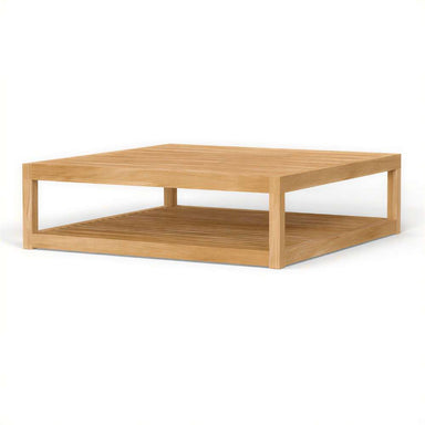 Wide angled shot shows Westminster Teak Maya Teak Coffee Table with its flat top surface and open rectangular base design