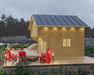 With modern lighting and vibrant red chairs, the Sawmill Structures The Jumbo Grand Loft 130 SD Garden Room offers a stylish and inviting outdoor space at dusk