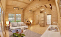 Wood-paneled living space in the Sawmill Structures Edwin Lake House PLUS 70MM Garden Room shows a white sectional sofa, kitchen area, and small workspace