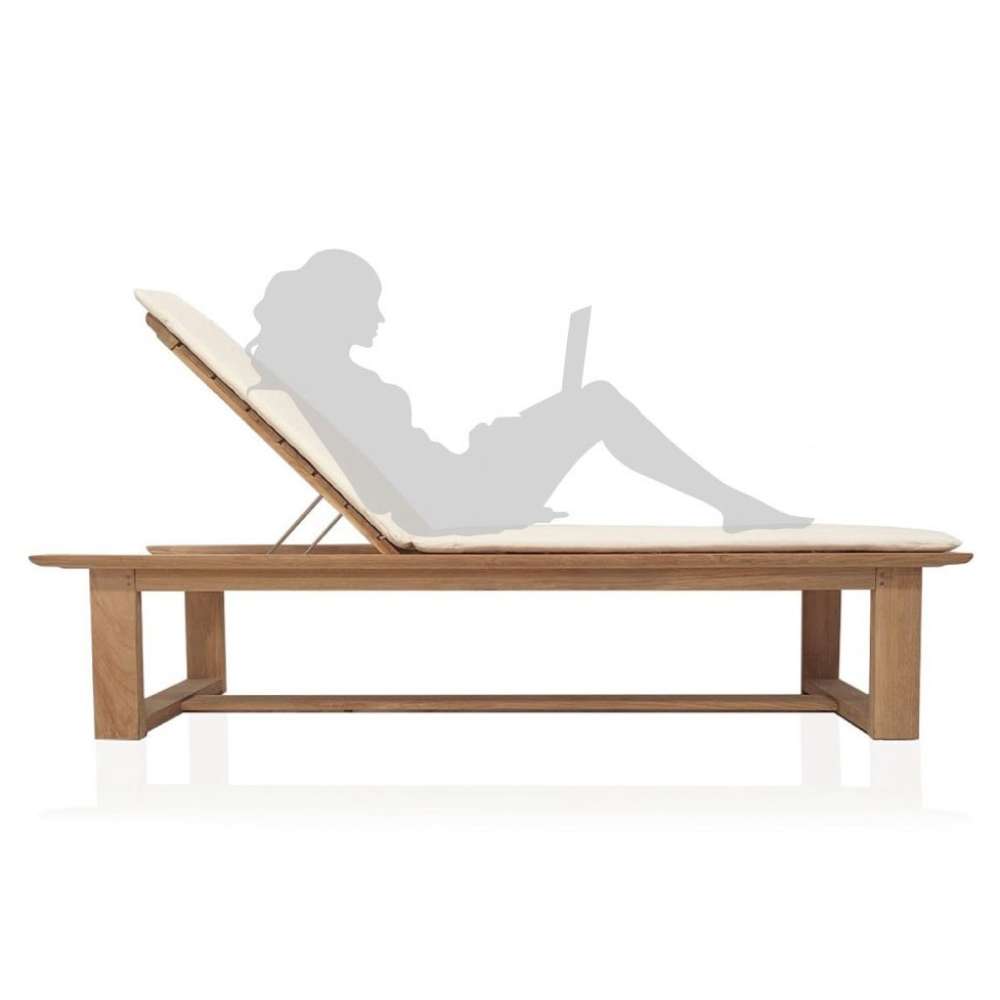 Wooden Westminster Teak Horizon High Chaise Lounger with a cream cushion is shown from the side, featuring a person silhouette reclining comfortably with a laptop