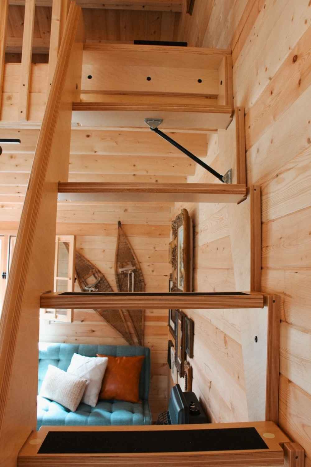 Wooden stairs with built-in traction lead to the loft area in the Sawmill Structures BlueWater Loft 160 38mm Garden Room