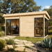 Rectangular light wood studio with glass sliding doors and windows, set in a garden with a stone path.