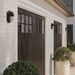 Black Crate & Barrel Maritime Black Outdoor Wall Sconce in matte black solid brass with a fluted glass shade over a single E12 socket, shown in the second alternate view