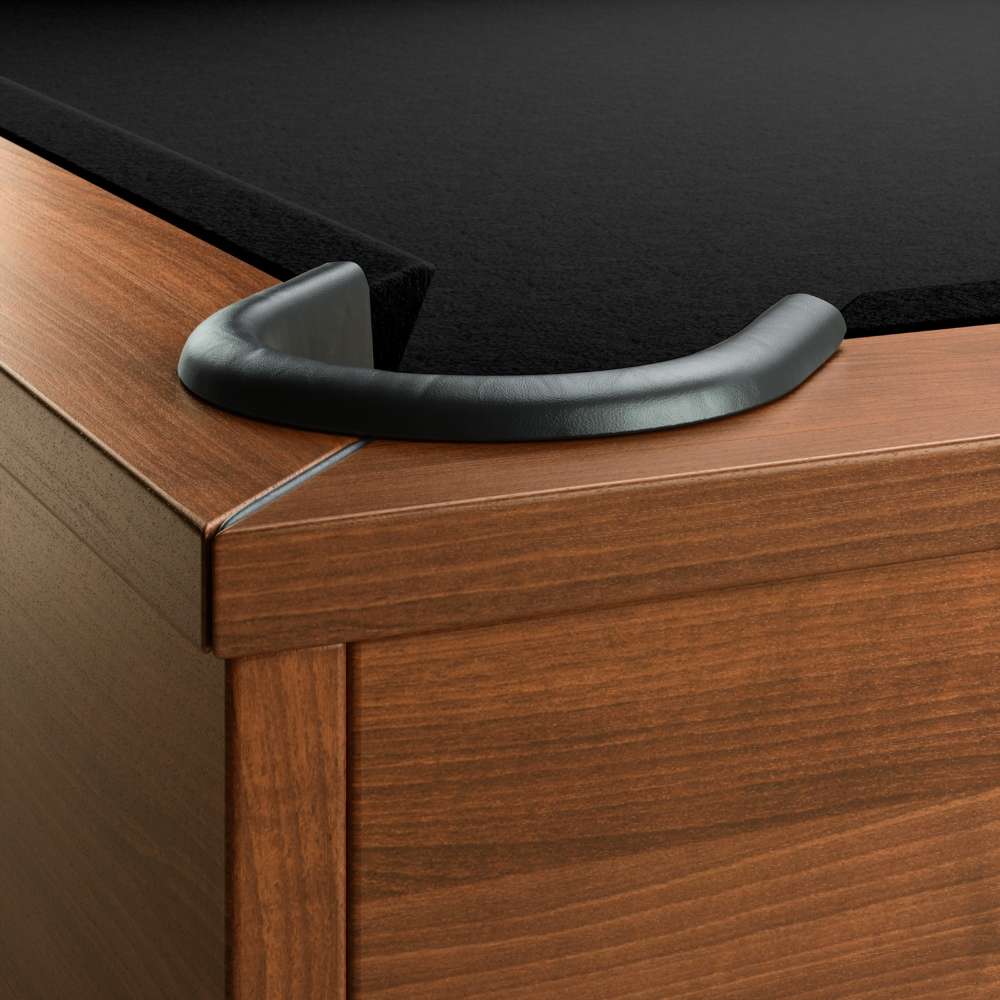Black Crate & Barrel Walnut Pool Table with Wall Rack and Accessories in close up on a corner pocket showing the black leather drop pocket, black felt and the walnut rail