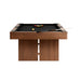 Black Crate & Barrel Walnut Pool Table with Wall Rack and Accessories seen from the corner against a white background with black felt, a rack of coloured balls, the cue ball and a cue on the rail