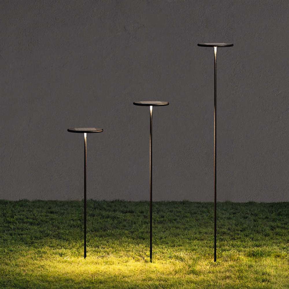 Black Crate & Barrel Zafferano Puck LED Outdoor Solar Lamp in black powdercoat cast aluminum with stainless steel screws and an integrated 3.2W LED bulb, shown in the first alternate view