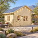 BlueWater Bungalow 160 configured as a sunny backyard office in Nevada, with two adults working inside the compact timber structure surrounded by upscale desert landscaping.
