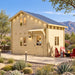 BlueWater Freedom Loft Studio configured as a sunny backyard office in Nevada, with two adults working inside the compact 160-square-foot timber structure.
