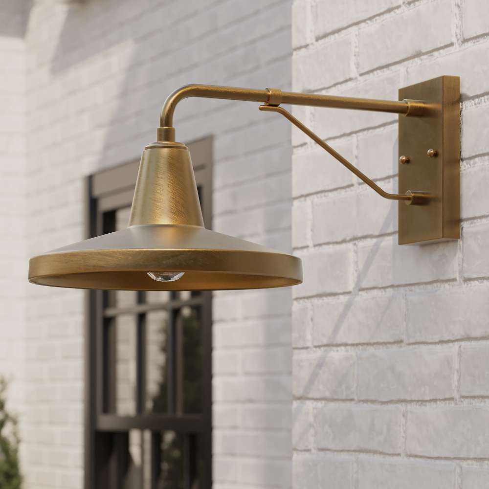 Brass Crate & Barrel Mariner Outdoor Wall Sconce in a side view showing the wall plate and downward-facing shade