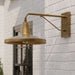 Brass Crate & Barrel Mariner Outdoor Wall Sconce in a side view showing the wall plate and downward-facing shade