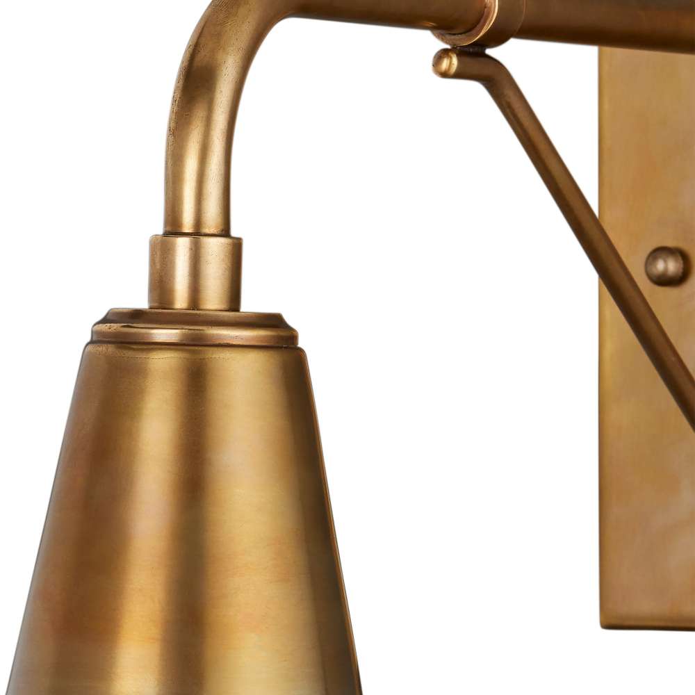 Brass Crate & Barrel Mariner Outdoor Wall Sconce mounted on an exterior wall casting warm downward light