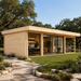 Rectangular light wood ALU Concept 70O studio with glass sliding doors, flat roof, and interior office space on a lawn.