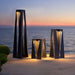 Cafe Brown Crate & Barrel Teatree Cafe Metal LED Solar Outdoor Lantern in carbon steel giving 500 lumens of warm 2,200K light, shown in the third alternate view