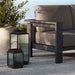 Close up detail of the Crate & Barrel Alfresco Black Metal and Glass LED Solar Outdoor Lantern showing the reeded glass and black steel frame