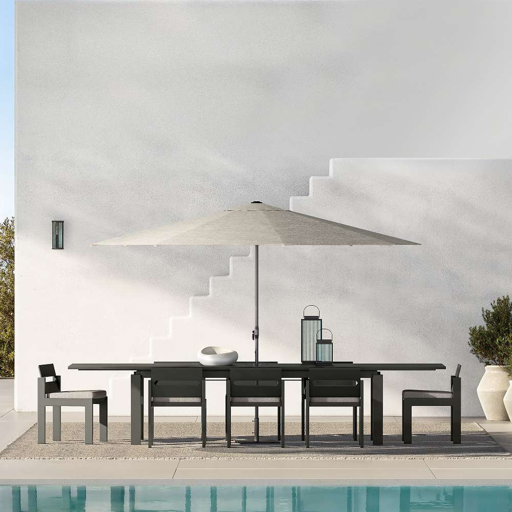 Crate & Barrel Alfresco Black Metal and Glass LED Solar Outdoor Lantern shown in an outdoor living space
