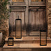 Crate & Barrel Alfresco Black Metal and Glass LED Solar Outdoor Lantern styled in an outdoor patio setting