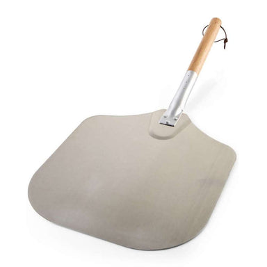 Crate & Barrel Metal Pizza Peel angled on a white background, the pale aluminum blade in the foreground and the wood handle with a leather hanging loop rising behind it.