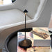 Dark Grey Crate & Barrel Pina Pro Metal Table Lamp by Zafferano America lit and styled on a table surface