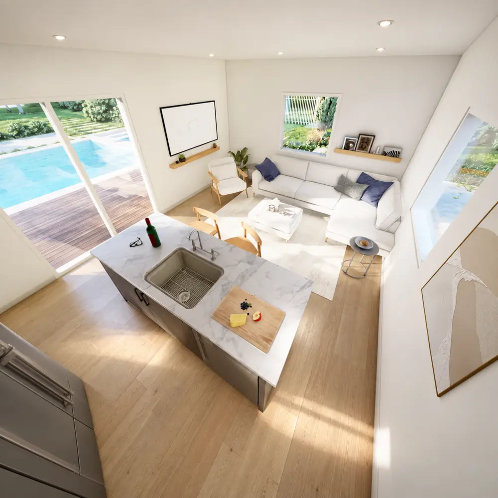 Elevated view inside the Banff Garden Suites showing a white sectional sofa, marble kitchen island, open-plan layout, and private pool beyond the windows.