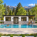 Centered view of the Tremblant one-bedroom Freedom Suite on a sunny Colorado day, with one adult swimming, another reading beside the pool, and a third arranging refreshments beneath green aspens and Rocky Mountain peaks.