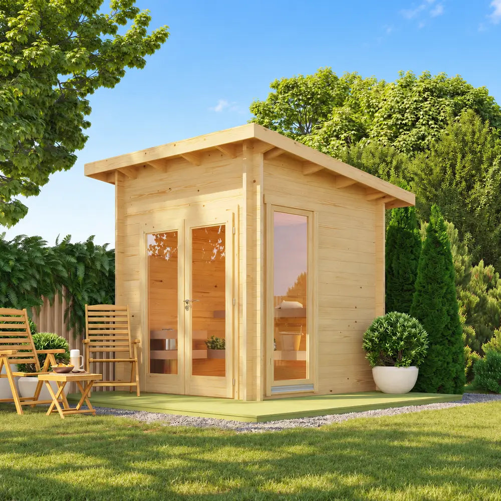 Sawmill Structures Versa Sauna in a sunny backyard with glass doors, a tall side window, wooden chairs, and lush landscaping.