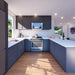 Bright kitchen inside the Muskoka Garden Suites featuring dark U-shaped cabinetry, white countertops, a stainless-steel stove, microwave, and full appliance suite.