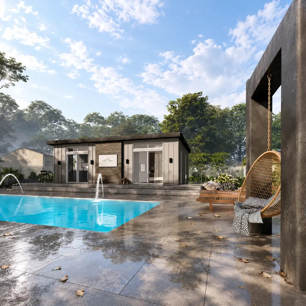 Side view of the Muskoka Garden Suites beside a pool with fountain jets, a hanging chair, lounge seating, trees, and a peaceful landscaped setting.