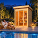 The illuminated TS TwoSauna beside a glowing pool on a bright Colorado night, with one adult meditating inside and another cooling down on a lounge chair beneath the stars and Rocky Mountains.