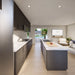 Bright Jasper Garden Suites interior with dark kitchen cabinetry, marble counters, a central island, cozy seating, and glass doors overlooking the pool.