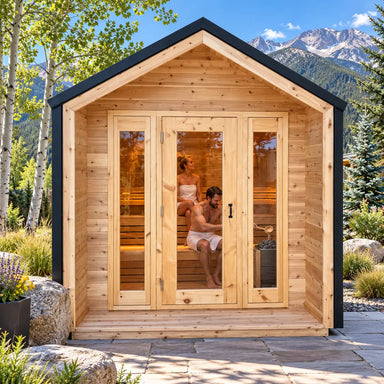 Front view of the CabinSauna on a sunny Colorado patio, with two adults relaxing inside as one pours water over the sauna stones, surrounded by aspens, evergreens and Rocky Mountain peaks.