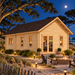 Farum 44 sports room illuminated at night among live oaks, maritime pines, sea oats, and coastal dunes on North Carolina’s Outer Banks.