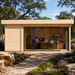 Rectangular light wood studio with glass sliding doors, two people working inside, and a stone path in the foreground.