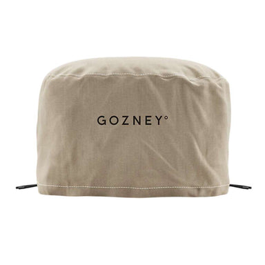 Gozney Arc Lite Pizza Oven Cover on white from the front showing the sand-colored canvas cover with the Gozney wordmark and drawcords at the hem.